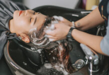 Beauty Salon Insurance: Best Companies, Costs and Coverage Directly above Asian chinese female lying down for hair wash at hair salon with eyes closed