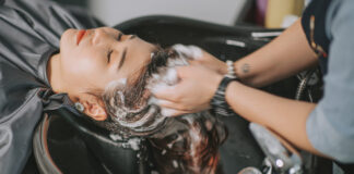 Beauty Salon Insurance: Best Companies, Costs and Coverage Directly above Asian chinese female lying down for hair wash at hair salon with eyes closed