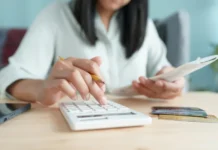 Millions Leaving SAVE Could Still Owe $0 Per Month — But Most Haven’t Run The Numbers Hand of Asian woman are calculating costs and payments. Source: The College Investor